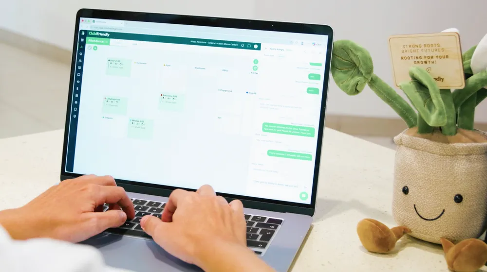 Hands typing on a laptop showing a ChildFriendly Pro schedule