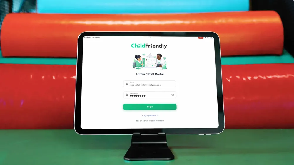 A tablet on a stand showing the ChildFriendly admin and staff login screen