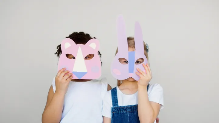 Children wearing paper animal masks they made at daycare