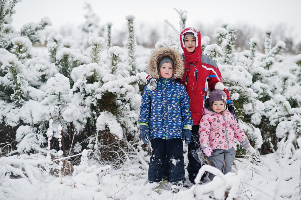 Siblings dressed in appropriate winter clothing for a snow day