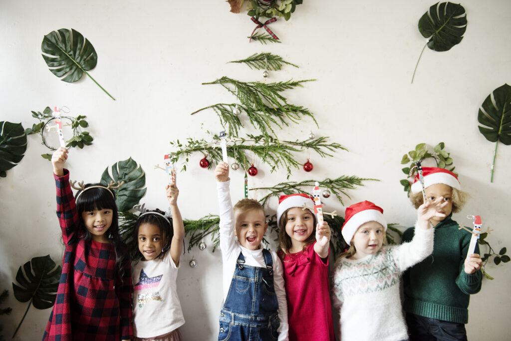 kids at a childcare center holding up their winter crafts.